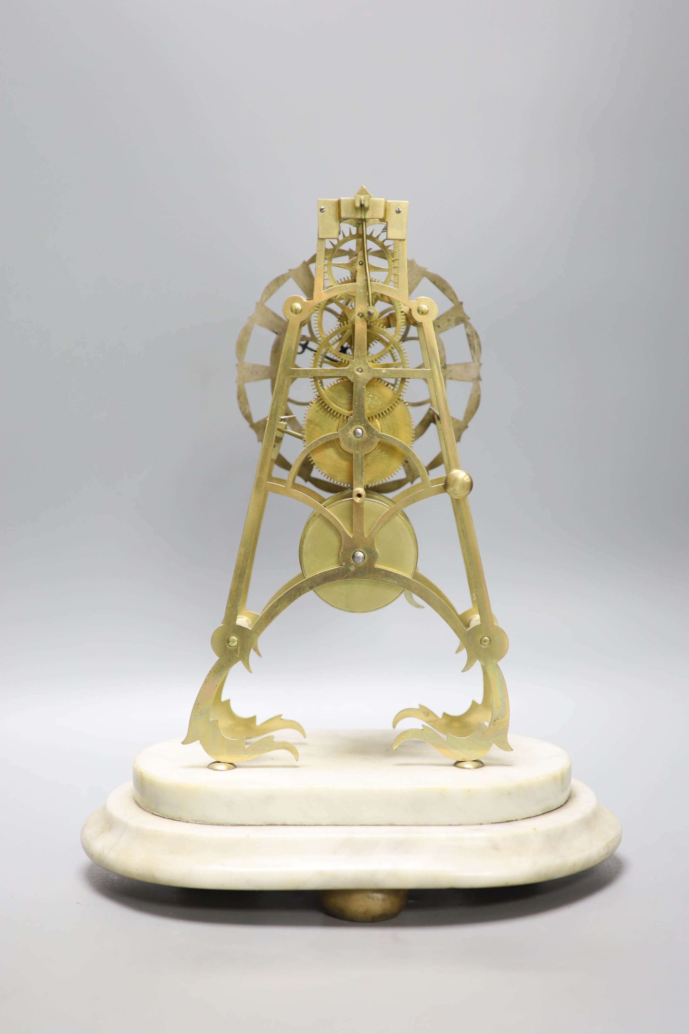 A 19th century brass skeleton clock on marble base. Associated glass dome, total height 44.5 cm